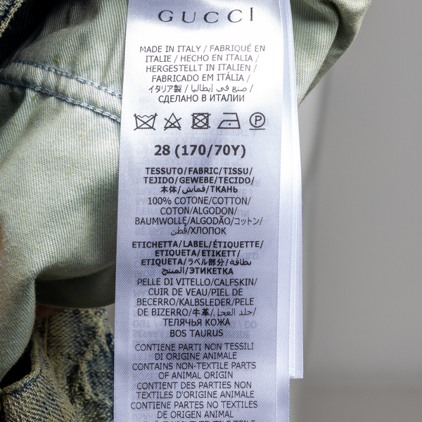 Faded effect jeans with logo pattern Gucci | Ratti Boutique